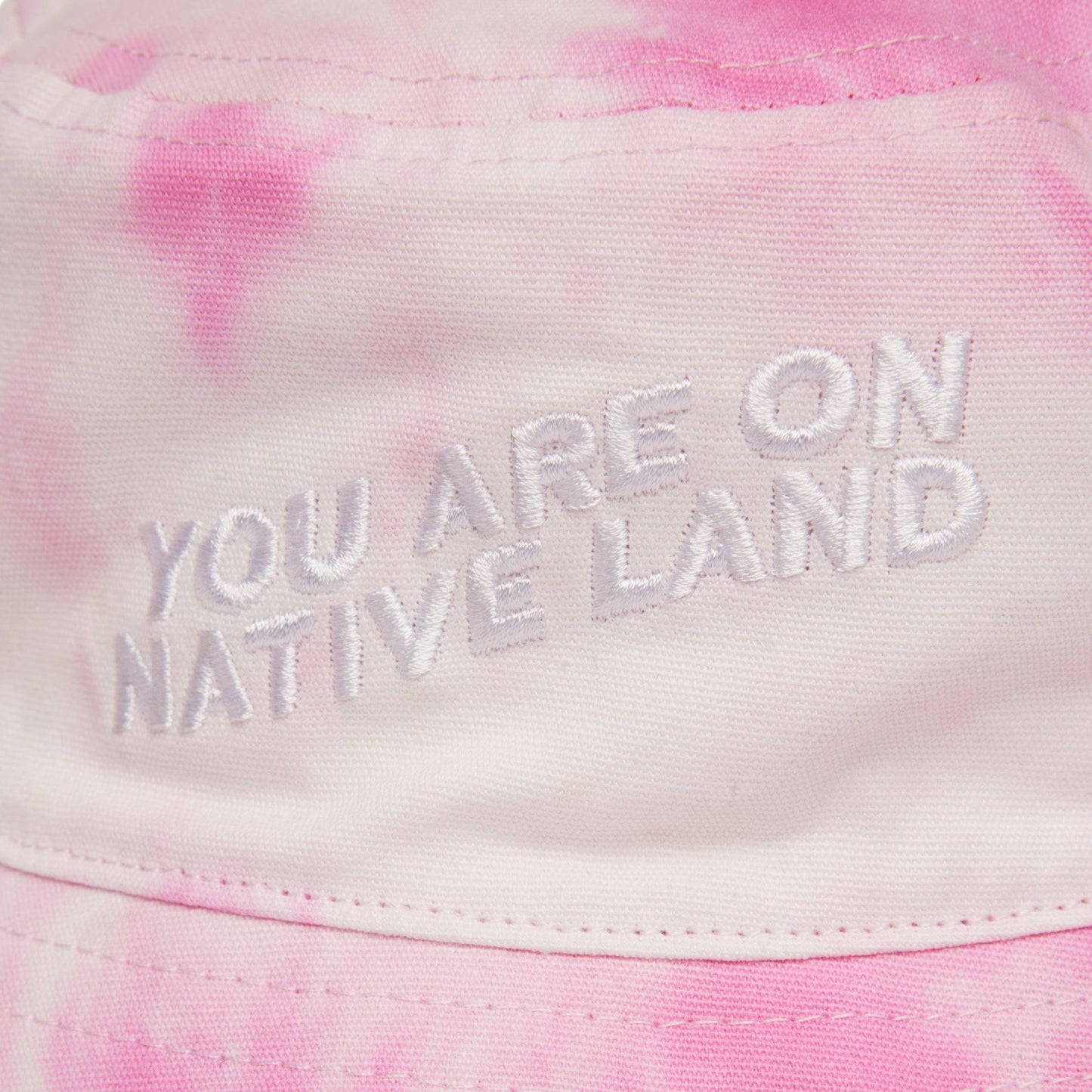 'YOU ARE ON NATIVE LAND' BUCKET HAT - PINK TIE DYE